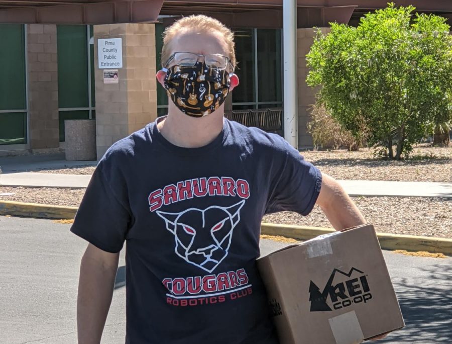 Mr.+Davis+delivering+a+box+of+face+shields+he+made