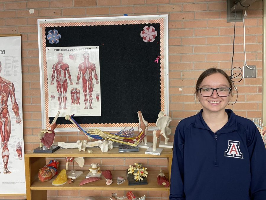 Monica Pita posing by human anatomy parts during her Sports Medicine class. 
