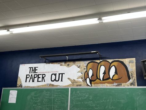 Our The Paper Cut sign in the back of the classroom