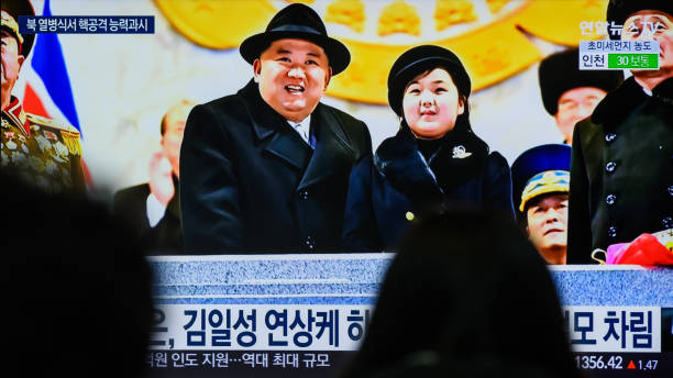 SEOUL, SOUTH KOREA - 2023/02/09: People watch a television screen showing a news broadcast with an image of North Korean leader Kim Jong-un (L) and his daughter presumed to be named Ju-ae (R) attending a military parade held in Pyongyang to mark the 75th founding anniversary of its armed forces, at Yongsan railway station in Seoul. North Korea has staged a massive military parade in Pyongyang to mark the 75th founding anniversary of its armed forces, its state media confirmed on February 9, describing intercontinental ballistic missiles (ICBMs) on display as representing the countrys maximum nuclear attack capabilities.
Its leader Kim Jong-un attended the nighttime event, held February 8, along with his wife, Ri Sol-ju, and apparent second child, Ju-ae, according to the Norths official Korean Central News Agency (KCNA). (Photo by Kim Jae-Hwan/SOPA Images/LightRocket via Getty Images)